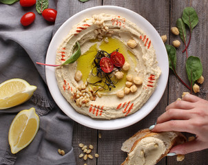 Oriental cuisine. Traditional snack hummus. It includes chickpeas, pine nuts, olive oil, spices and...