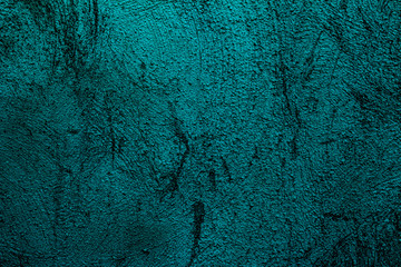 Petrol colored wall texture background with textures of different shades of petrol also called teal