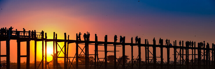 Sunset behind U Bein Bridge over Taungthaman Lake Amarapura Myanmar