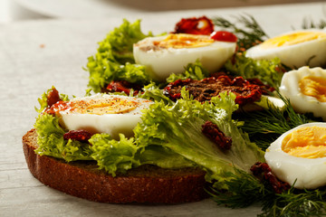 Fresh boiled egg with lettuce, parsley and dill. Healthy nutrition. Morning breakfast. Healthy organic natural food concept. View from above