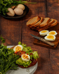 Fresh boiled egg with lettuce, parsley and dill. Healthy nutrition. Morning breakfast. Healthy organic natural food concept. View from above