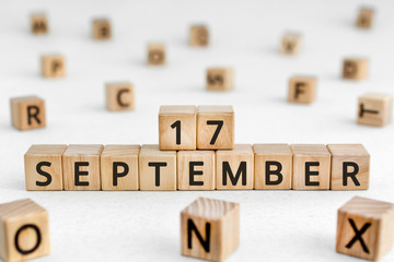 September 17 - from wooden blocks with letters, important date concept, white background random letters around