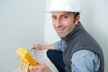 electrician testing if socket has electric current