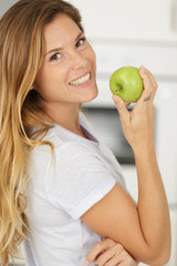 woman with green apple at home