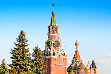 scenic kremlin skyline of moscow city russia with spasskaya clock tower and st. basil cathedral...