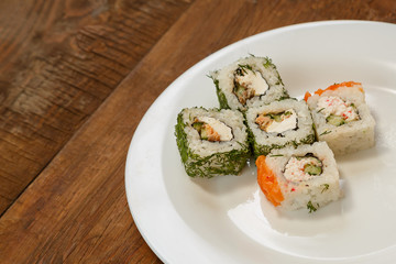 rolls with dill and salmon with soy sauce, ginger and chopsticks.
