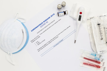 Coronavirus Vaccine concept with syringe and blue respirator mask.