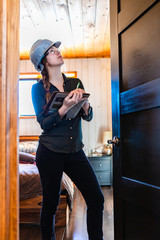 worker woman wears a grey hard hat look up. female construction inspector reviews a room door during home inspection as she holding clipboard.