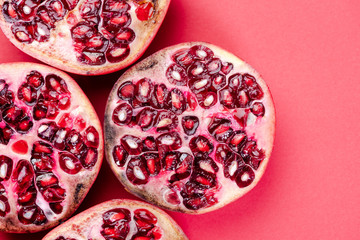 Pomegranate Fruit Halves on Reg Background. Top Down Flat Lay with Copy Space