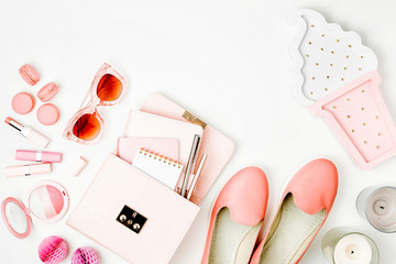 Flat lay of female fashion accessories, shoes, makeup products and handbag on pastel color background. Beauty and fashion concept