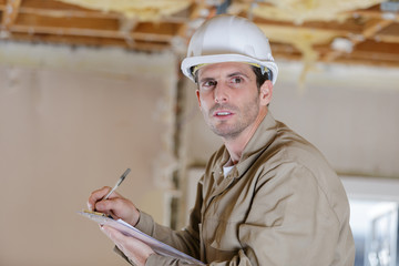 a builder in with clipboard