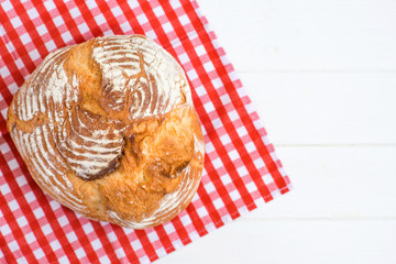 Fresh bread with napkin on kitchen table
