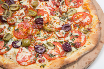Vegetarian pizza or pizza with onions, mixed olives, mushrooms  and tomato with a white background
