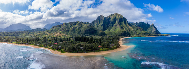 Aerial panoramic image off the coast over Tunnels beach on Hawaiian island of Kauai with Na Pali mountains behind © steheap