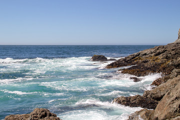 Waves splashing over rocks at the ocean shore