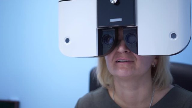 The doctor checks the eyesight of the patient. Foropter electronic automatic. Eye clinic. Health prophylaxis.