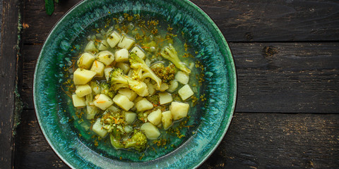 soup broccoli, broth and other vegetables (vegetarian first course) keto or paleo diet menu concept. background. top view. copy space