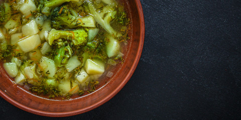 soup broccoli, broth and other vegetables (vegetarian first course) keto or paleo diet menu concept. background. top view. copy space