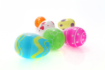 Colorful Easter egg toys on white with selective focus and shallow depth of field