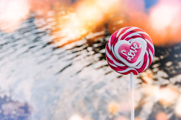 Striped red and white lollipop with Love