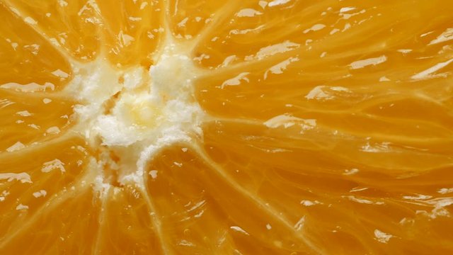 Fresh yellow organic orange slice in extreme close up macro