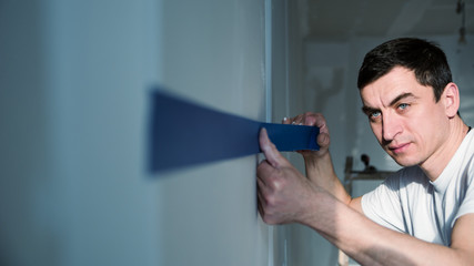 Painter using blue color Masking Tape