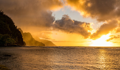 Sunset lights the receding cliffs of the NaPali coastline on north coast of Kauai in Hawaii