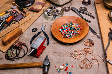 handmade copper wire working tools on the table with accessoires. handicraft people art concept