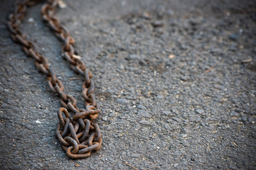 Heavy chain with corrosion on asphalt