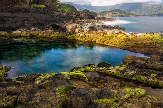 Long exposure of the calm waters of Queen's Bath, a rock pool off Princeville on north shore of Kauai