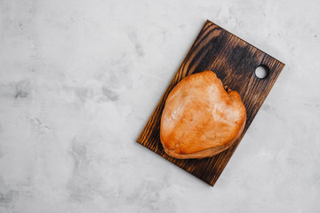smoked chicken breast on a wooden Board on a light background