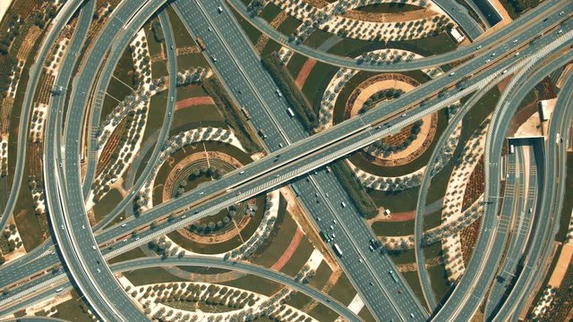 Aerial top down view of a big highway interchange traffic in Dubai, UAE