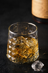 Elegant glass of whiskey with ice.
