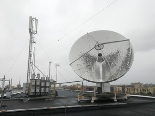 Satellite parabolic dish antenna on the roof for high speed internet link - obrazy, fototapety, plakaty