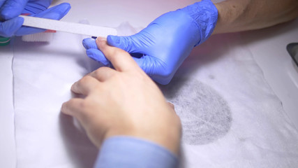 close-up. manicure. deburring scissors. manicure process for men.