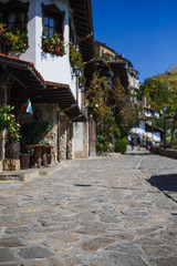Cobblestone and stone-tiled streets of the old tourist part of the city of Bulgaria. Typical Bulgarian houses made of stone and wood in old Sozopol, Nessebar, Veliko Tarnovo