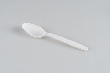 White, plastic, disposable spoon isolated on a white background.