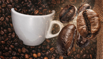 background with coffee beans falling on a cup of coffee