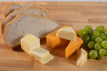 Overview of cheese bread tray with butter green grapes healthy snack foods