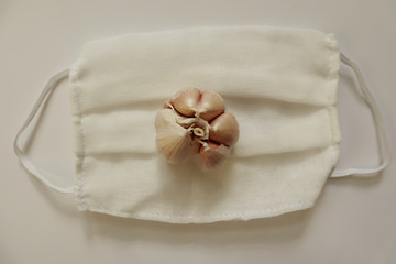 Garlic on a gauze bandage on a white background