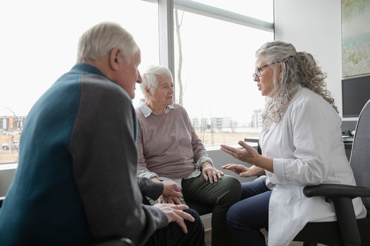 Doctor Explaining To Senior Couple