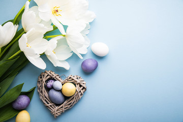 Naturally colorful dyed Easter eggs on blue background. Happy Easter holiday theme, banner