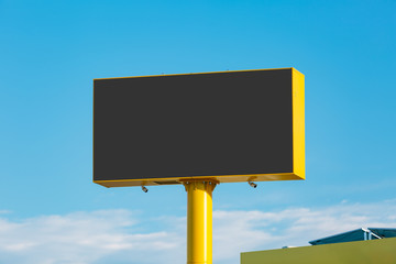 large advertising banner over blue sky with clouds, with the center cut to place your advertising