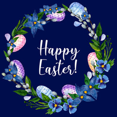 Easter wreath of colored eggs, greenery, blue flowers and willow branches