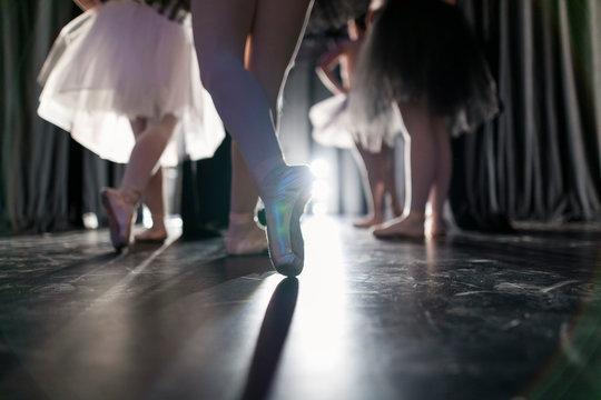 Young Female Ballerina In Ballet Shoes Off Stage