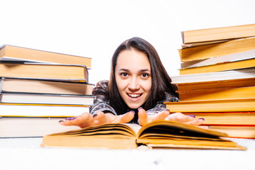 World Book Day. Young woman love to read. Photo of Russian brunette in books on a white background.