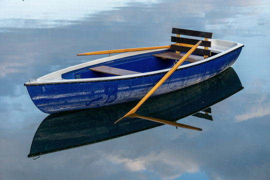 Image of wooden rowing boat on lake