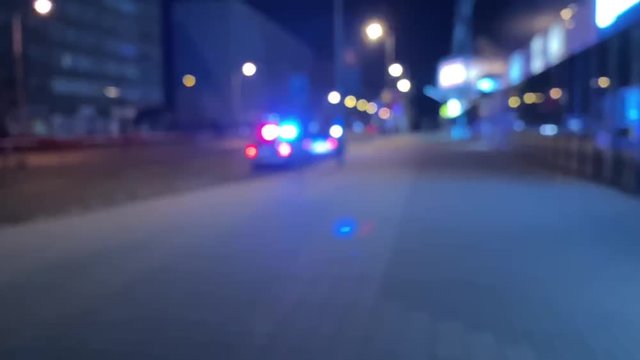 Defocused emergency lights of police or ambulance car at night
