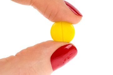 Pills in woman hand isolated on white background