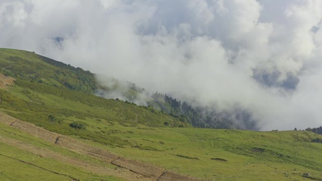 Aerial view people looking at amazing mountains with clouds. Summer season
